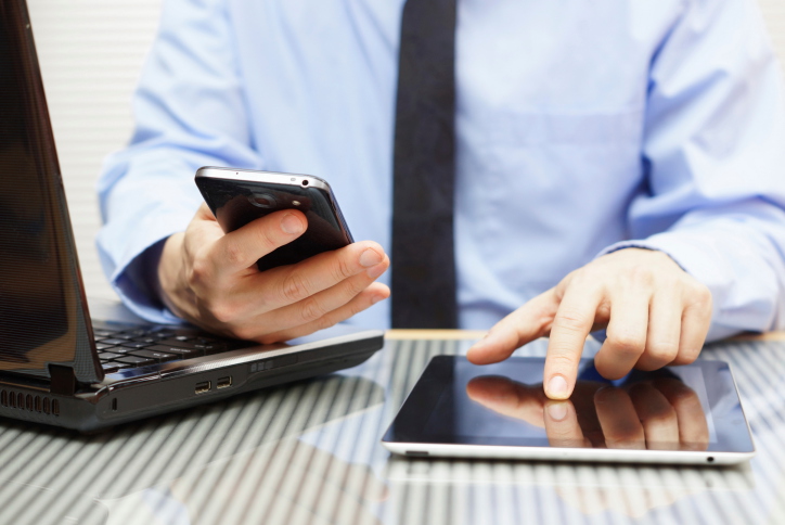 businessman is working on tablet and using smart phone